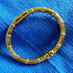 Hinged gold tone with silver accents cuff bracelet.